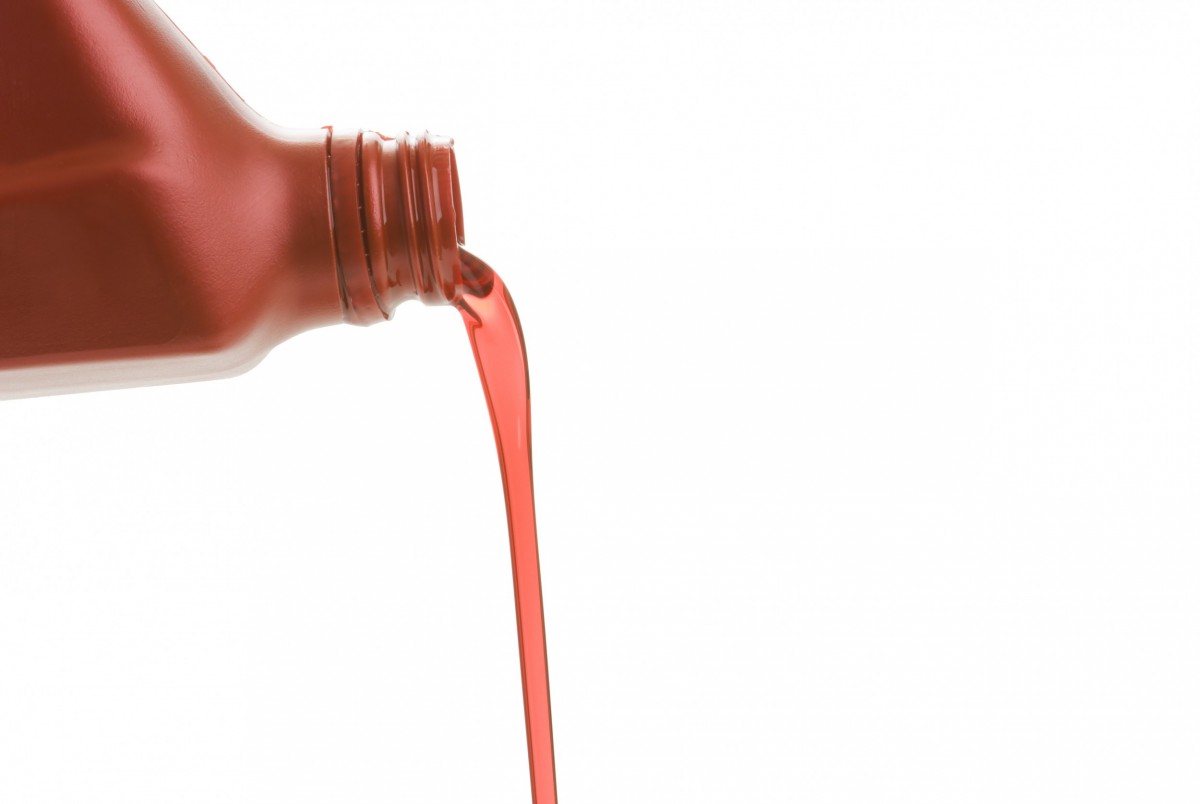 Fluid being poured into vehicle 