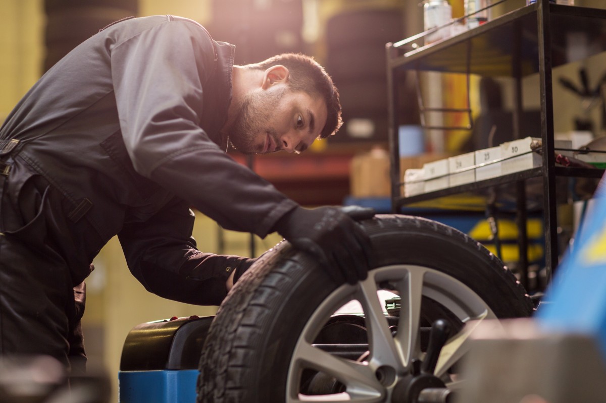 mechanic checking on tire