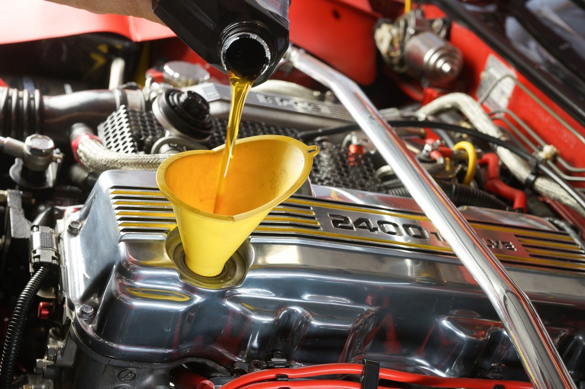 oil being poured into a funnel