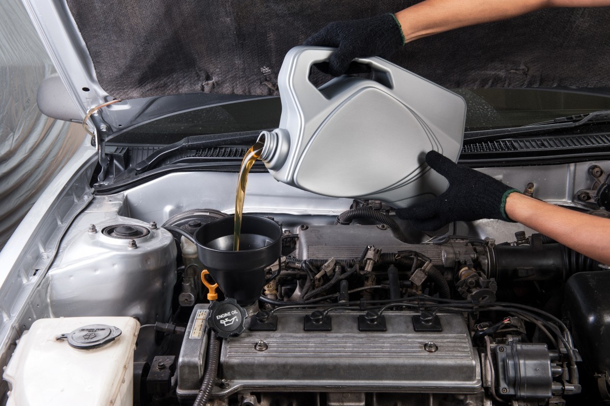 oil being poured into a funnel